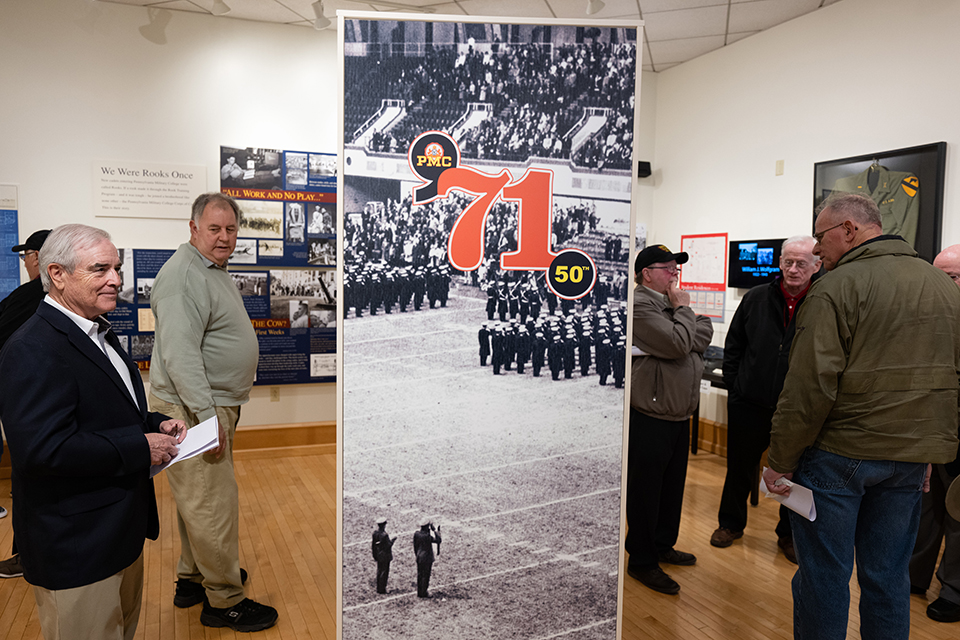 Alumni enjoy imagery from 1971 on display in the PMC Museum. 
