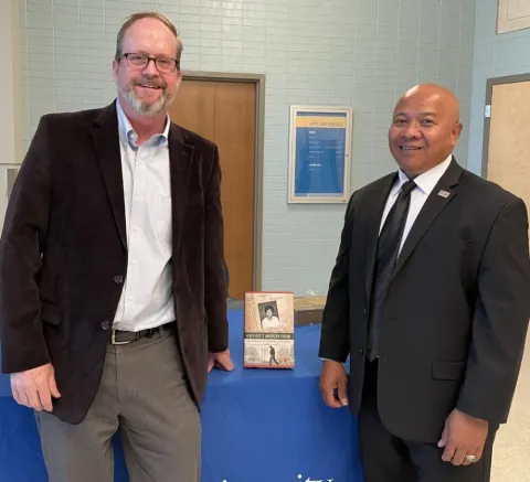 Sam Starned and Leth Oun pose with his book 