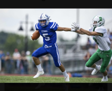 An action photo of BSN student Cole Livingston making a play on the football field.