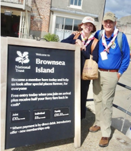 bill and trish guglielmi pose near Brownsea Island sign