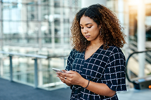 Business professional on phone at top of escalator