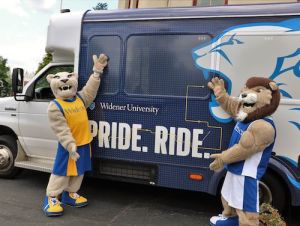 Pride Ride bus shuttle w/ mascots 500x375 Widener Mascots post with Widener Bus that reads PRIDE. RIDE. with lion graphic