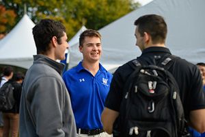 Students networking during business career day event, outside at Old Main