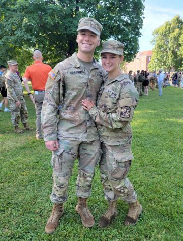 Kevin Draeger and Meghan Rampolla in Army fatigues pose for a photo