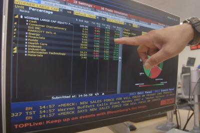 Finger pointing at stock investment screen