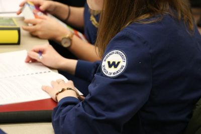 Nursing student in scrubs in a lab
