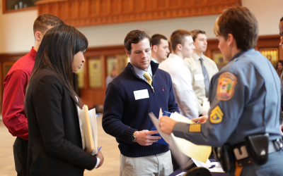 Widener students speaking with law enforcement officer during criminal justice career fair