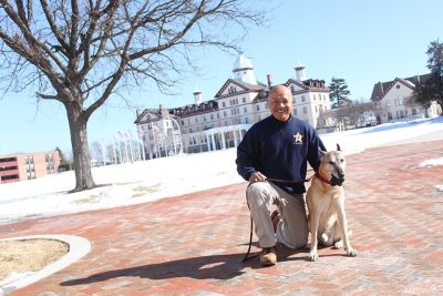 Leth Oun and his dog pictured on campus in the winter