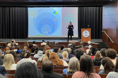 Amanda Bickerstaff speaks on stage in front of a crowd