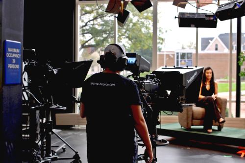 Filming the virtual Veterans Parade show Person filming one of the hosts of the virtual Veterans Parade show in the TV studio