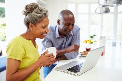 OLLI couple on laptop 960x640 mature couple drinking coffee together at laptop