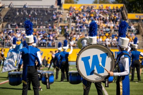 The marching band performs on the field at Homecoming.