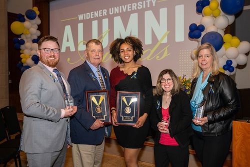 Alumni Awards Magazine 960x640 L to R: Ryan Raiker, Col. Tom Vossler, Donya Moore, Jill Borin, and Marcia Zaruba O’Connor pose with their awards.